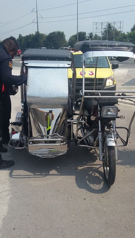 A Tricycle Driving Through NLEX